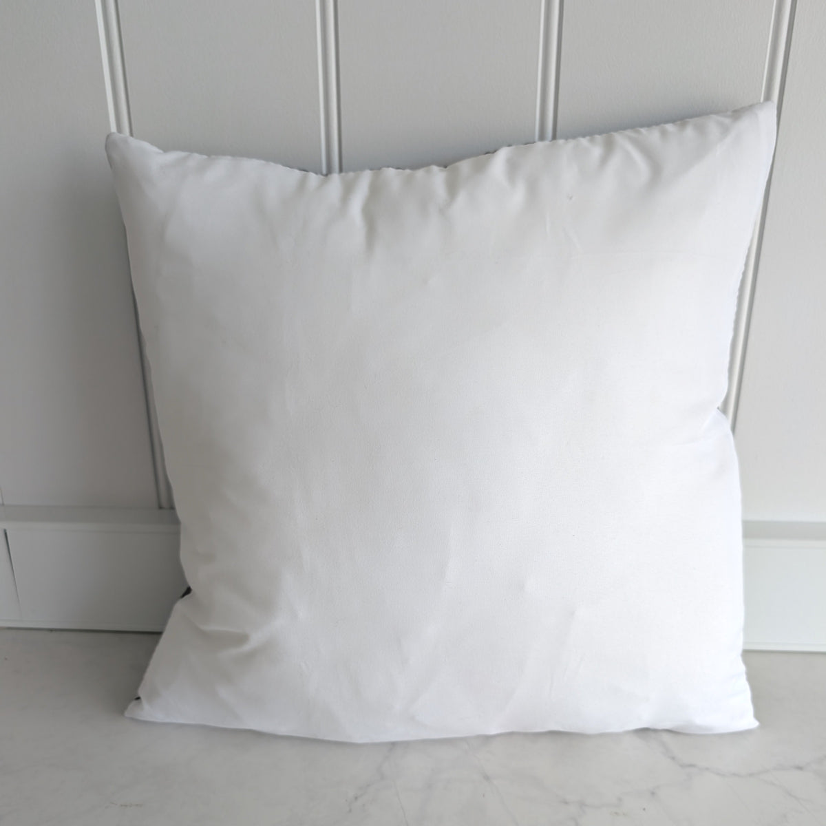 Plain white reverse of the cushion