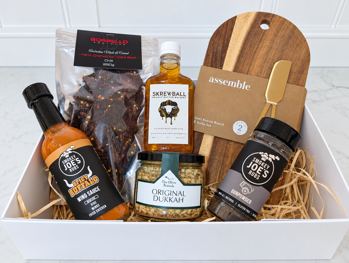 The Fireside Feast Gift Box with Skrewball whiskey, chilli jerky, buffalo sauce, dukkah, barbecue rub and acacia board