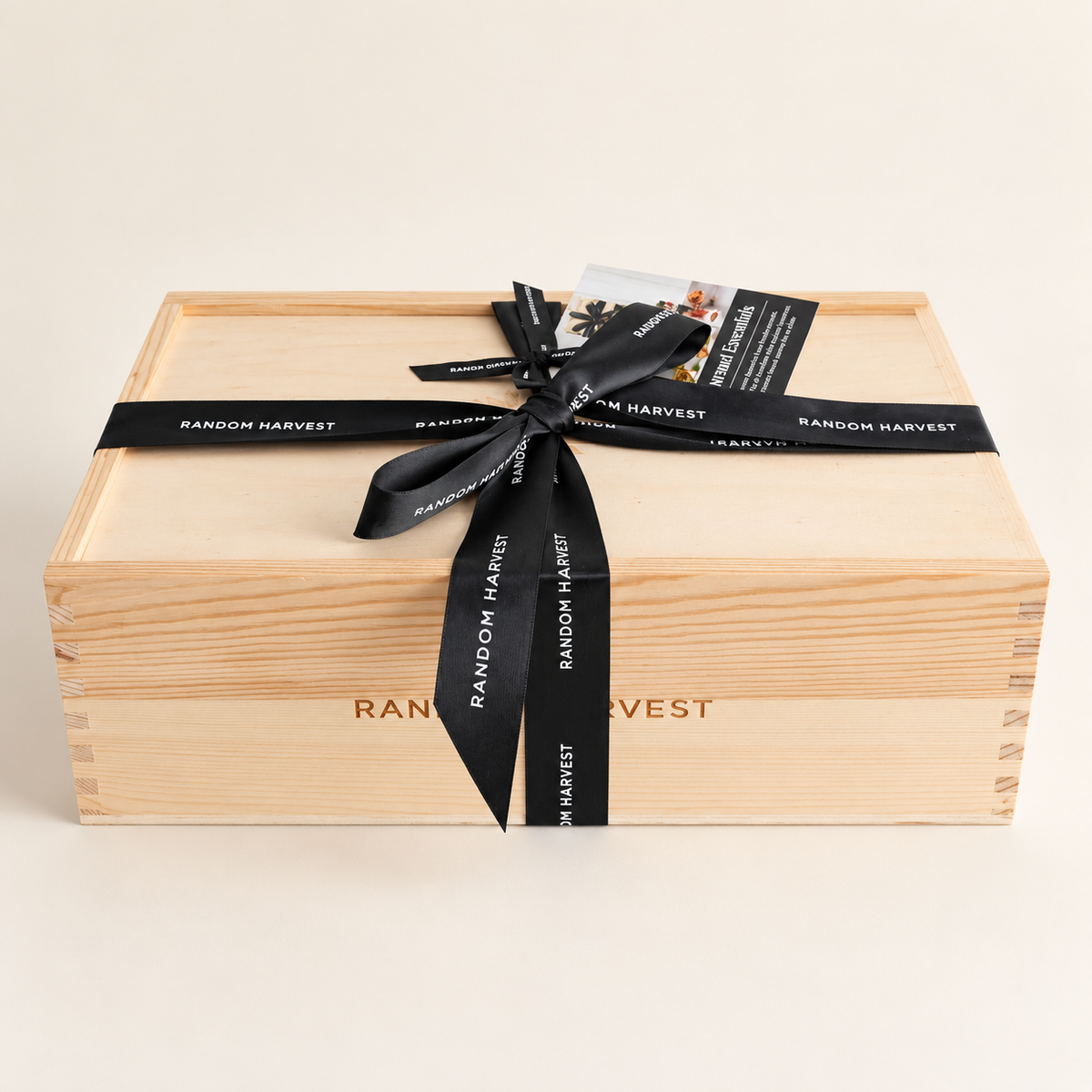 Random Harvest wooden gift box viewed from above with black branded ribbon and bow