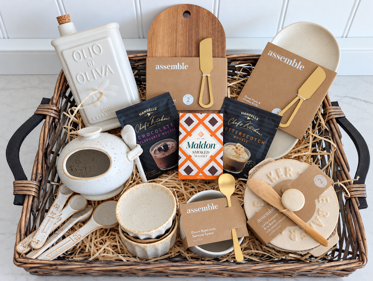 The Savour & Sweet Hamper in a willow tray with ceramic kitchenware, acacia serving board, smoked sea salt and two mousse mixes