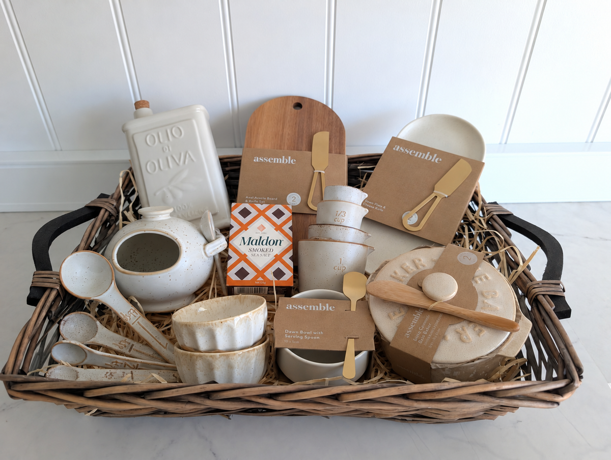 The Gather & Graze Hamper showing the full willow tray and both handles, with ceramic kitchenware and acacia serving board