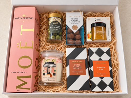 Rosé Celebration Gift Box with Moët & Chandon Rosé Impérial Champagne, Koko Black chocolates and macadamias, mango cocktail pearls and a large SZOFI & CO candle.