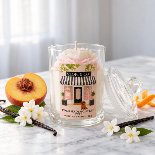 SZOFI & CO Coco Mademoiselle Type 320g soy wax candle with a pink flower embed, styled on marble with peach, jasmine and vanilla.