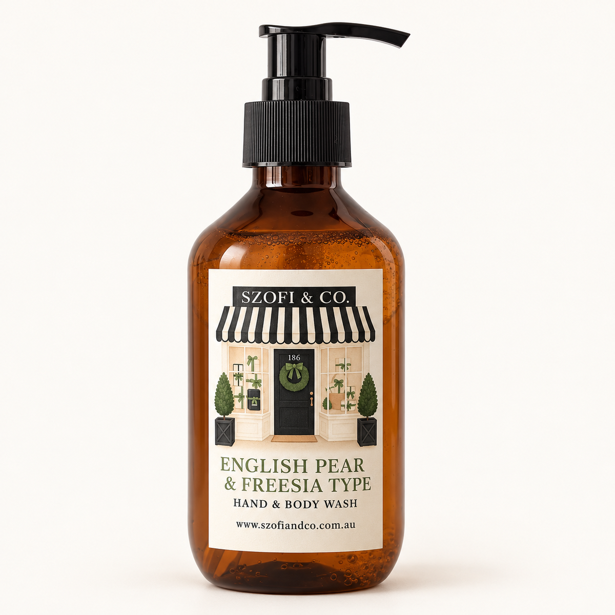 SZOFI & CO English Pear & Freesia Type Hand & Body Wash in an amber pump bottle on a warm ivory background