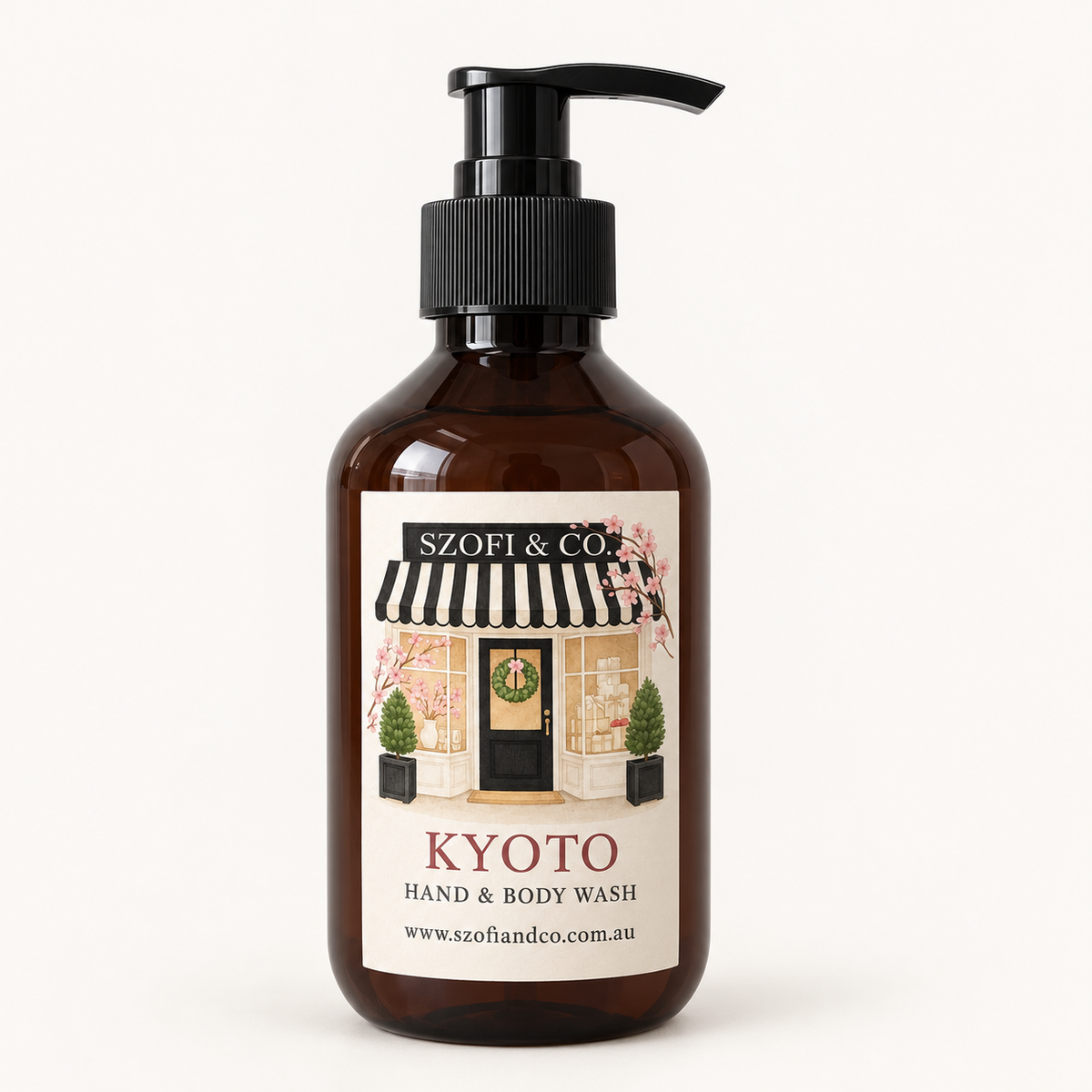 SZOFI & CO Kyoto Hand & Body Wash in an amber pump bottle on a warm ivory background