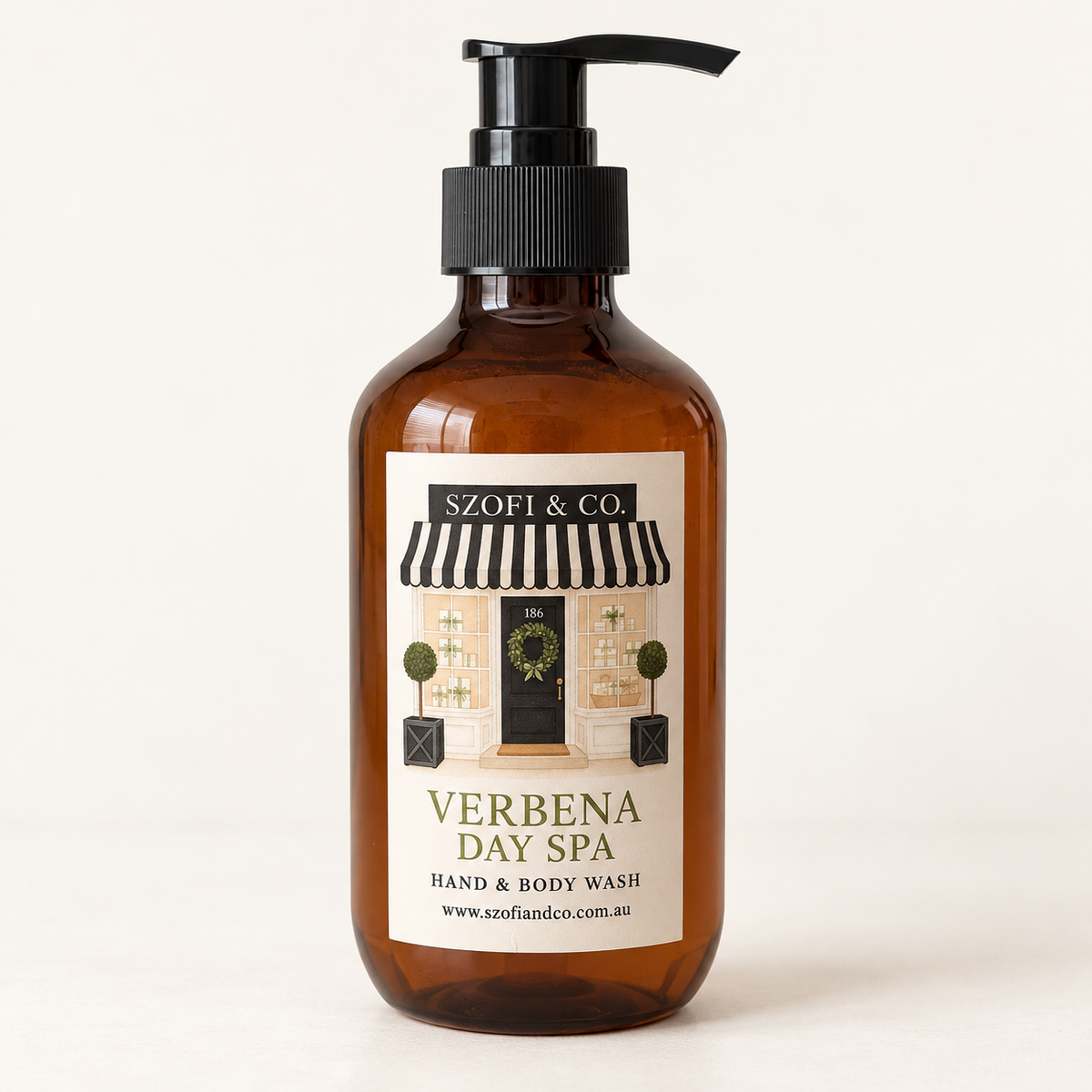 SZOFI & CO Verbena Day Spa Hand & Body Wash in an amber pump bottle on a warm ivory background